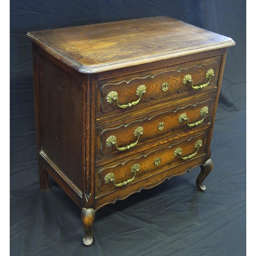 1655 - A continental oak chest of rectangular outline, the top with a moulded edge, containing three drawer... 