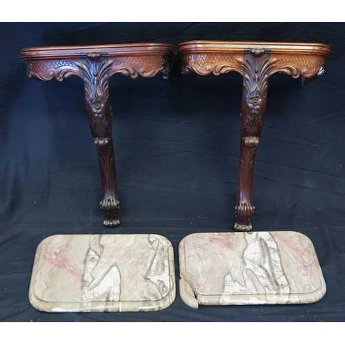 1656 - A pair of carved mahogany console tables, with rectangular marble tops, with foliate and scrolled fr... 