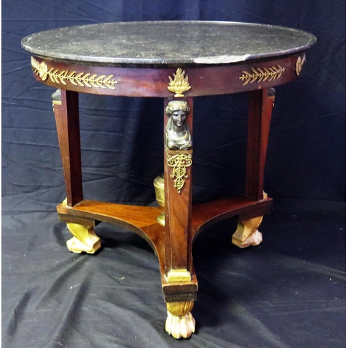 1657 - A 19th century French Empire Egyptian revival circular table, with black marble top with a moulded e... 