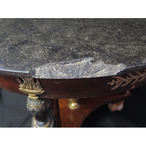 1657 - A 19th century French Empire Egyptian revival circular table, with black marble top with a moulded e... 