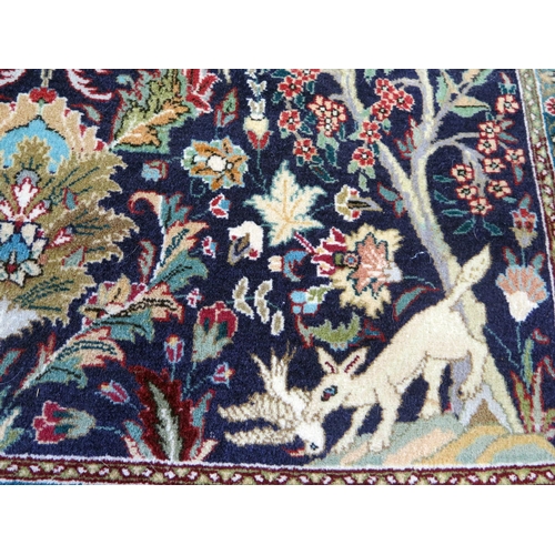 1662 - A Persian silk and wool prayer rug, the indigo mihrab with a garden design of animals and birds amon... 