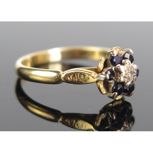 181 - An 18ct Gold, Sapphire and Diamond Cluster Ring, stamped 18CT, 9mm head, size M.5, 3.04g