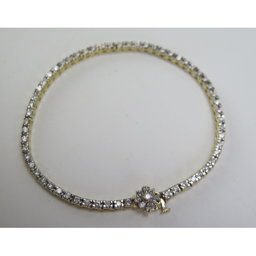 190 - A 14K Gold and Diamond Line Bracelet with 9 stone cluster clasp, stamped 14K, 7.25