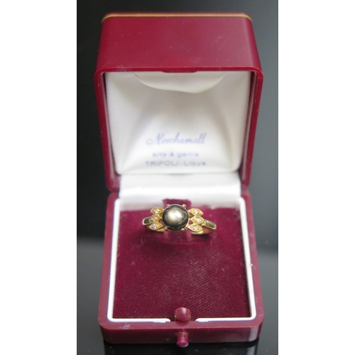 200 - A Libyan Star Sapphire and Diamond Ring in an unmarked precious yellow metal setting, KEE tested as ... 