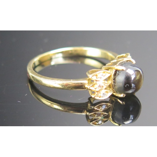 200 - A Libyan Star Sapphire and Diamond Ring in an unmarked precious yellow metal setting, KEE tested as ... 