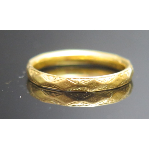 202 - A 22ct Gold Wedding Band with chased decoration, 2.8mm wide, size L.5m Birmingham 1959, 2.9g