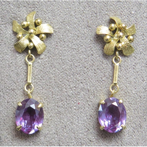 203 - A pair of Middle Eastern 18ct Gold and Purple Sapphire Pendant Earrings, 35mm drop, butterflies stam... 