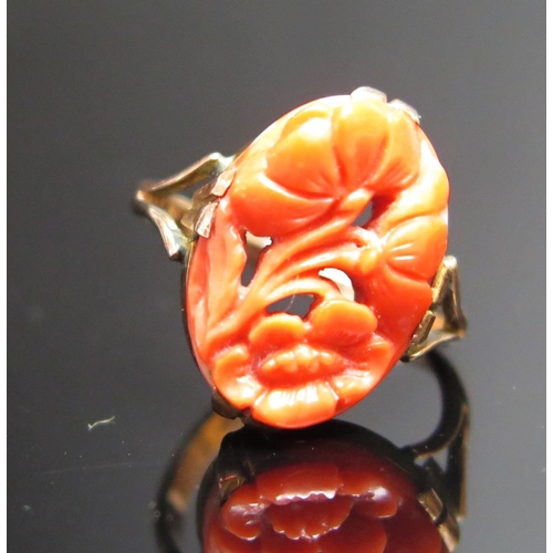 211 - An Antique Carved Coral Ring with pierced foliate decoration, stamped 9CT, 16x10.5mm stone, size D, ... 