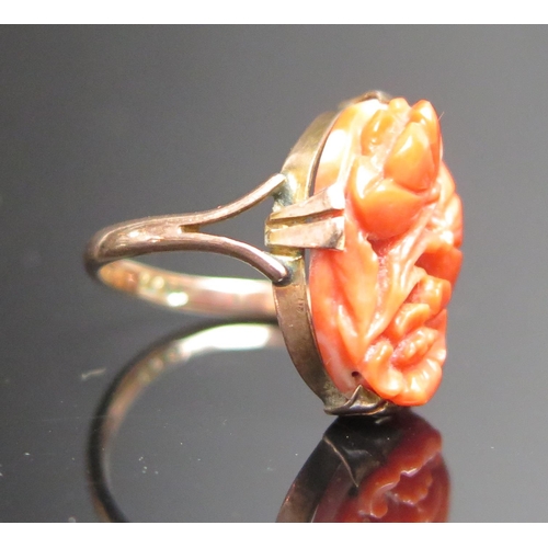 211 - An Antique Carved Coral Ring with pierced foliate decoration, stamped 9CT, 16x10.5mm stone, size D, ... 