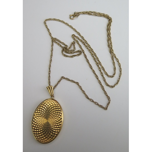 218 - A Large 9ct Gold Decorative Oval Locket, hallmarked, 41mm drop, 7.57g and on a gold plated chain