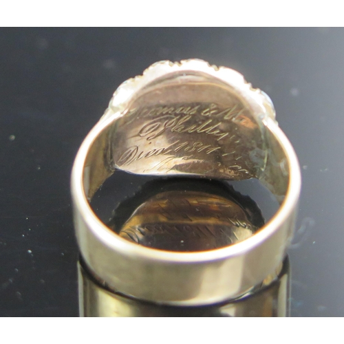 223 - A Georgian Memorial Ring with a central crystal panel containing a locket of hair and surrounded by ... 