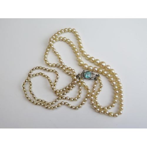 238 - A Twin Strand untested Pearl Necklace with 18ct gold and platinum clasp set with zircon and diamonds... 