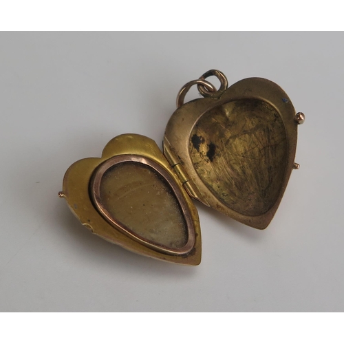 255 - A 19th Century Precious Yellow Metal and Enamel Heart Shaped Locket decorated with Cupid, 27.5mm dro... 