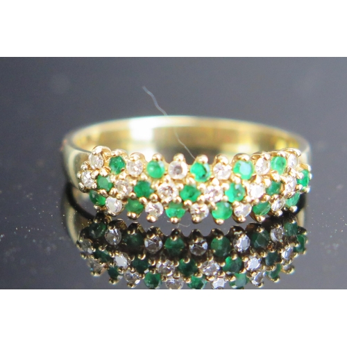 261 - A 9ct Gold, Emerald and Diamond Three Row Ring, hallmarked, 2.07g