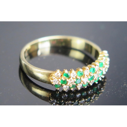 261 - A 9ct Gold, Emerald and Diamond Three Row Ring, hallmarked, 2.07g