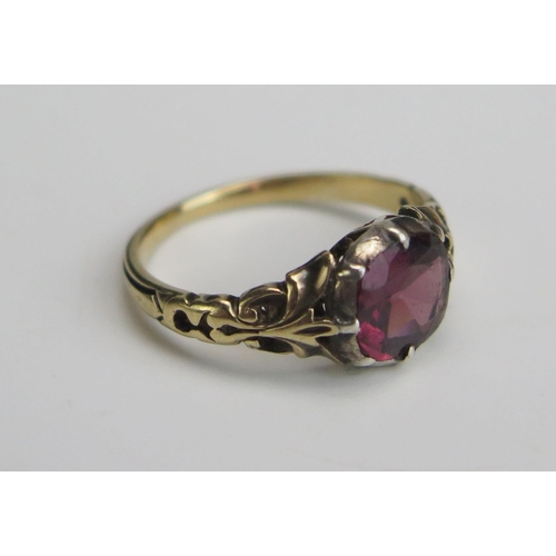 264 - A Garnet or Paste Ring in a precious yellow metal setting, KEE tested as 15ct, size H.25, 2.24g