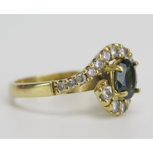 331 - An 18ct Gold, Green Sapphire and Diamond Cross Over Ring, stamped 750, c. 7.2x5.9mm principal stone,... 