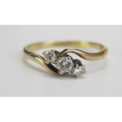 336 - An 18ct Gold and Diamond Three Stone Crossover Ring, central stone 3.5mm, stamped 18CT, size Q, 2.69... 