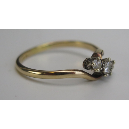 336 - An 18ct Gold and Diamond Three Stone Crossover Ring, central stone 3.5mm, stamped 18CT, size Q, 2.69... 