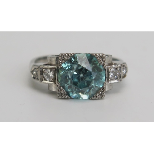 340 - A Blue Zircon and Diamond Deco Style Ring in a precious white metal setting, 8.5mm principal stone, ... 