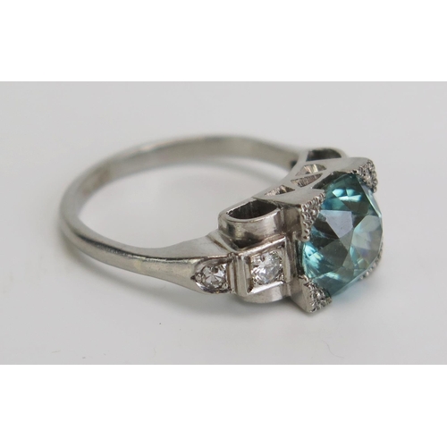 340 - A Blue Zircon and Diamond Deco Style Ring in a precious white metal setting, 8.5mm principal stone, ... 