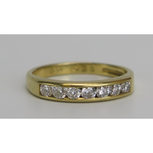 343 - An 18ct Gold and Diamond Seven Stone Ring, hallmarked, .5ct channel set diamonds, size M.5, 3.28g