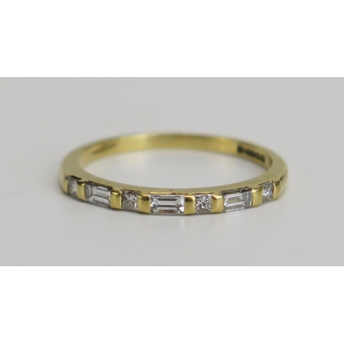 346 - An 18ct Gold and Diamond Ring set with seven brilliant round cut and baguette cuts, hallmarked, size... 