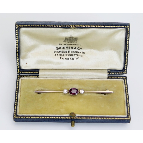 357 - A Ruby and Diamond Bar Brooch in a precious white metal setting, the millegrain set pigeon blood rub... 