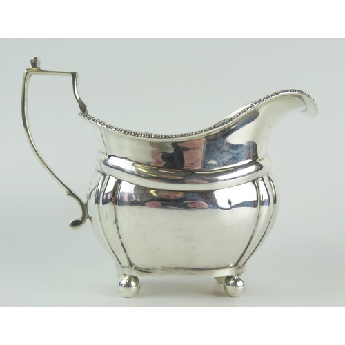 592 - A George V silver cream jug, maker C S Harris & Sons Ltd, London, 1916. of barge-shaped outline with... 