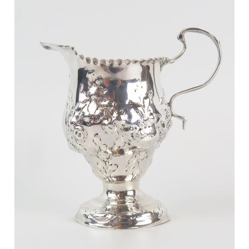 597 - A George III silver pedestal cream jug, makers mark worn, London, 1771, with crimped border, embosse... 