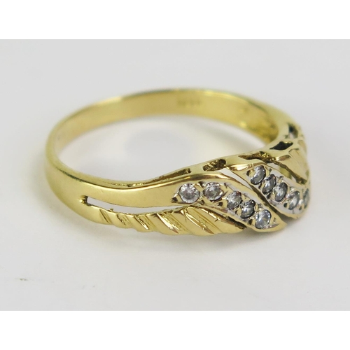 69 - An 18ct Gold and Diamond Dress Ring, set with ten c. c. 1.2mm stones, stamped 18CT, size O, 2.78g