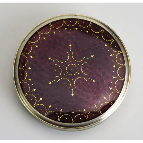 720 - A continental silver and enamel box and cover of circular outline, with gilded interior, 5cm diamete... 