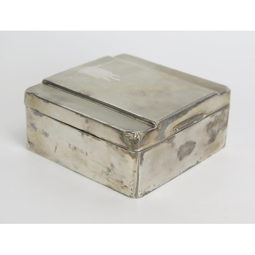 740 - A silver Art Deco period cigarette box, all marks worn, with engine turned decoration, 9cm wide.