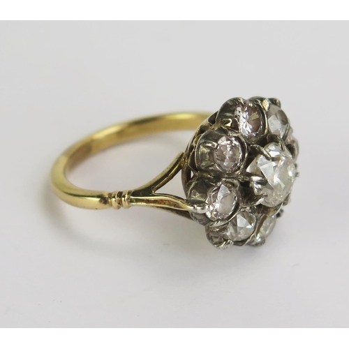 76 - An Antique Diamond Cluster Ring, 6mm claw set principal stone with eight c, 3.8mm satellite stones, ... 