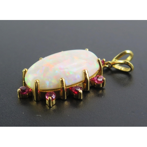 83 - An 18ct Gold, Opal and Ruby Pendant, 24x13mm principal singlet stone, 3mm rubies, 39mm overall drop,... 