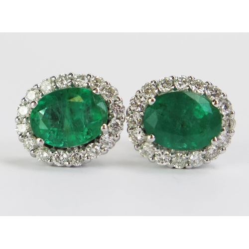 93 - A Pair of 18ct White Gold, Emerald & Diamond Cluster Stud Earrings, stamped 18K, 11.5x10mm heads, 4.... 