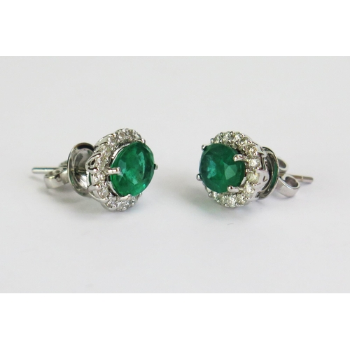 93 - A Pair of 18ct White Gold, Emerald & Diamond Cluster Stud Earrings, stamped 18K, 11.5x10mm heads, 4.... 