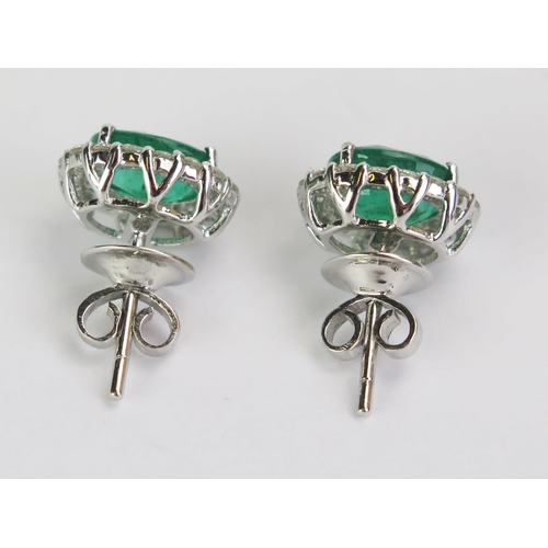 93 - A Pair of 18ct White Gold, Emerald & Diamond Cluster Stud Earrings, stamped 18K, 11.5x10mm heads, 4.... 