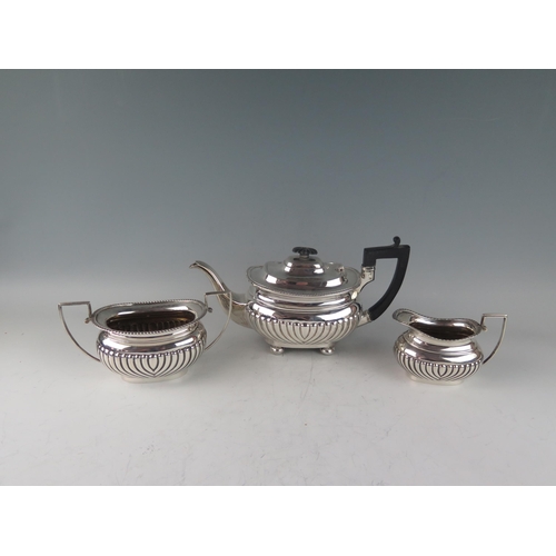 500 - A matched three-piece silver tea service, of barge-shaped outline, the teapot  maker GAG, Sheffield,... 