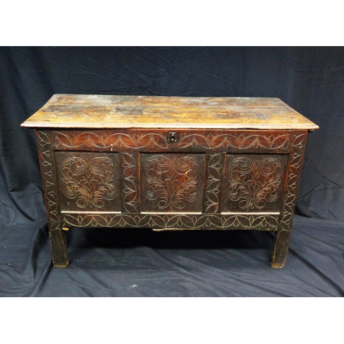 1609 - A late 18th century carved oak coffer, the rectangular hinged top with triple carved panelled front,... 