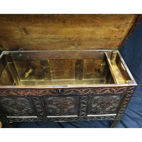 1609 - A late 18th century carved oak coffer, the rectangular hinged top with triple carved panelled front,... 