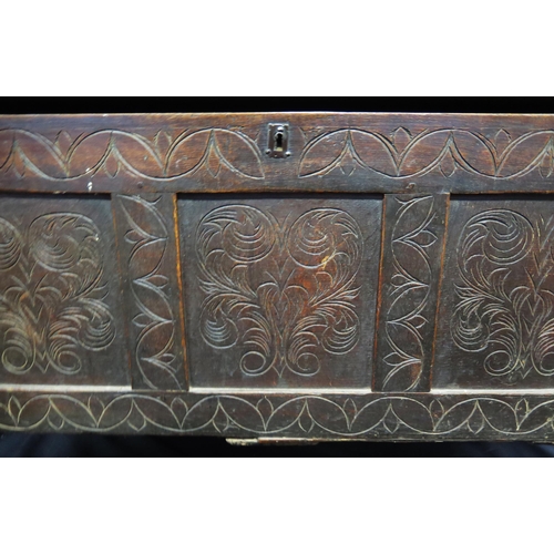 1609 - A late 18th century carved oak coffer, the rectangular hinged top with triple carved panelled front,... 