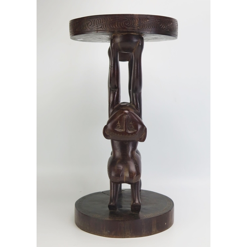 1663 - A Massim stool, Trobriand Islands, Papua New Guinea
with a carved circular top on a standing figure ... 