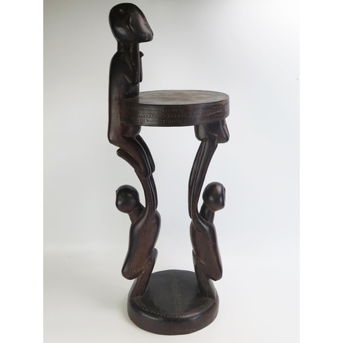 1664 - A Massim stool, Trobriand Islands, Papua New Guinea
with a carved circular top on crouching figural ... 