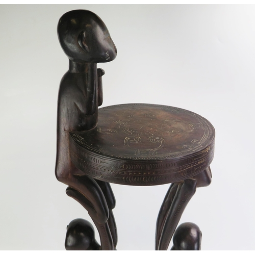 1664 - A Massim stool, Trobriand Islands, Papua New Guinea
with a carved circular top on crouching figural ... 