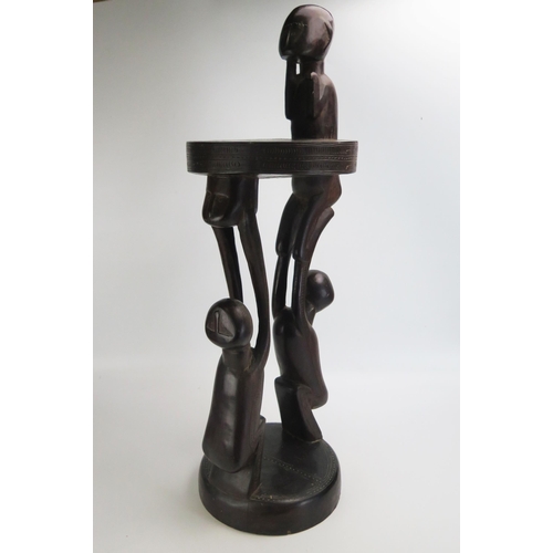 1664 - A Massim stool, Trobriand Islands, Papua New Guinea
with a carved circular top on crouching figural ... 