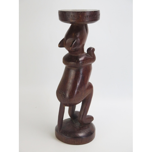 1665 - A Massim stool, Trobriand Islands, Papua New Guinea
with a carved circular top on a single standing ... 