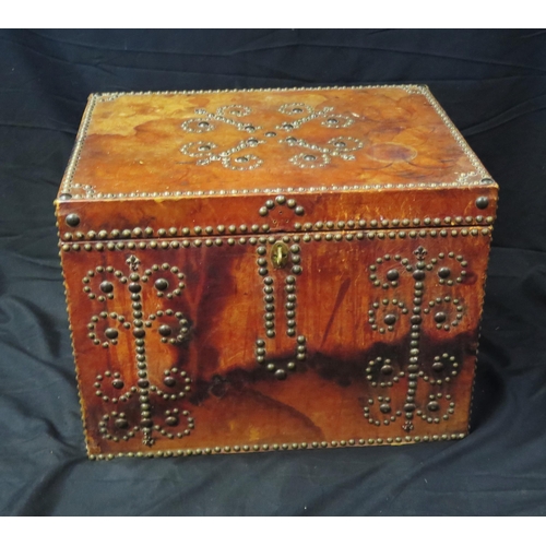 1680 - A red leather bound trunk, with metal stud decoration, having a hinged rectangular top, 51cm wide.