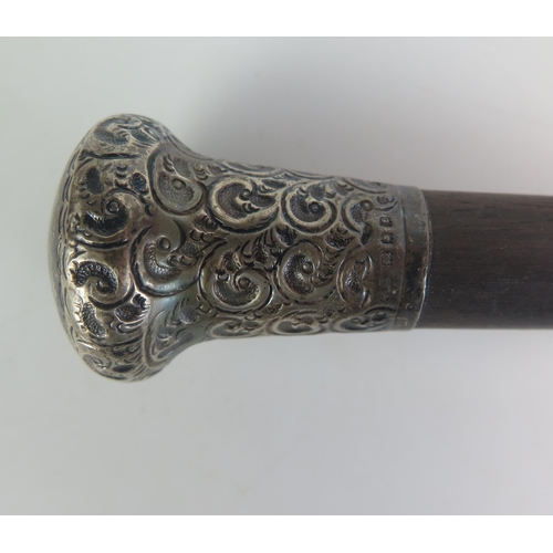 581 - An ebonised and silver mounted walking stick, together with and ebonised walking stick with silver m... 