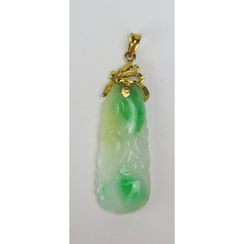 102 - A Carved Jade Pendant in a precious yellow metal mount, stamped 850, 51.8mm drop, 6.33g